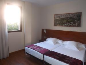 Postel nebo postele na pokoji v ubytování Hotel Reus Park