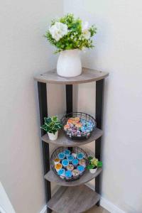 a wooden shelf with a vase with flowers on it at Gruene Getaway in New Braunfels
