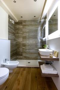 a bathroom with two sinks and two toilets at Florentia Art Apartments in Florence +37 photos