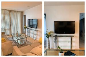 a living room with a flat screen tv and a couch at Cozy Condo in Centre of Downtown Toronto in Toronto +4 photos
