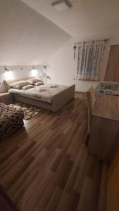 a bedroom with a large bed and a desk in it at Apartment Slap in Rakovica