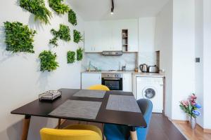 a kitchen with a table and yellow chairs in a room at Luxury Art 4 Apartment in Blagoevgrad +10 photos