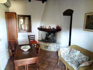 a living room with a table and a fireplace at Agriturismo Bio Pian Dei Casali in Saturnia