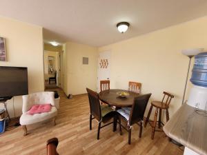a living room with a table and chairs and a television at Atacama Valley 3 in Copiapó