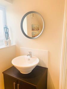 a bathroom with a sink and a mirror at Inviting townhouse in Bedlington in Bedlington