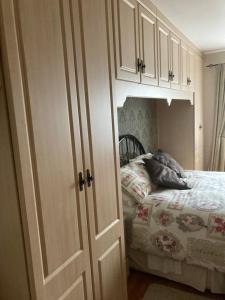 a bedroom with a bed and a white cabinet at Deeleview apartment in Lifford