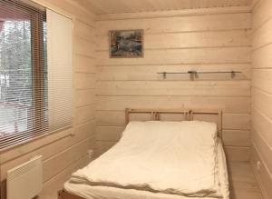 a small room with a bed in the corner at Holiday Cabin Kerimaa 90 in Kerimäki