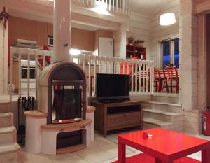 a living room with a fireplace and a tv at Holiday Cabin Kerimaa 90 in Kerimäki