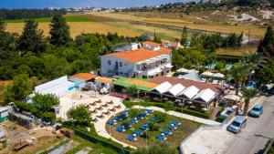 an aerial view of a resort with a pool and tables at Fitosinn Hotel in Paphos
