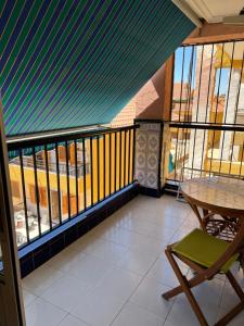 a balcony with a table and chairs and a fence at Apartament La Mata in La Mata