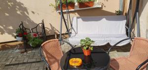 a table and two chairs on a balcony with a chair and a table at Vintage Apartment - Ultracentral, 2 dormitoare in Sighişoara