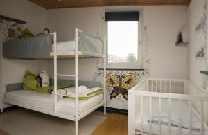 Cette chambre comprend 2 lits superposés et une fenêtre. dans l'établissement feworld living - near Salzburg city, à Freilassing