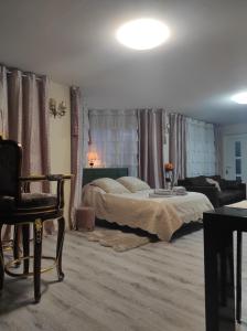 a bedroom with a bed and a living room at Gite Luxury***** avec Bar à Soultzeren in Soultzeren