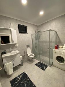a bathroom with a shower and a toilet and a sink at Sky Villas Hisar in Trabzon +45 photos