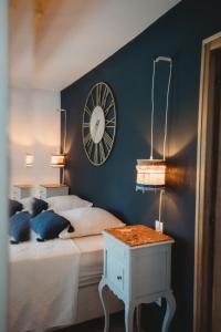 a bedroom with a bed and a clock on the wall at Mas des Ecoliers in Châteaurenard +42 photos