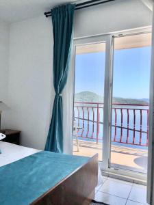 a bedroom with a bed and a sliding glass door at Villa Anita in Sobra