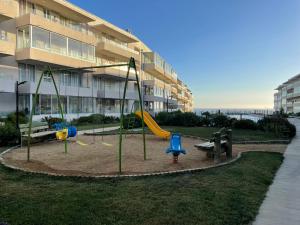 a playground in front of a apartment building at Departamento con Vista Al Mar in El Tabo
