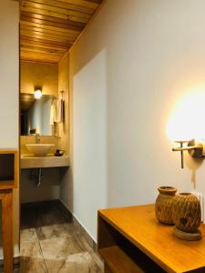 a bathroom with a sink and a table with a vase on it at Hotel Mar&iacute;a del T&iacute;o Molcas in Creel