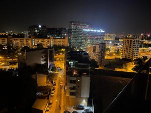 a city skyline at night with buildings and cars at Riverside Luxury Apartment Near President Palace in Bucharest