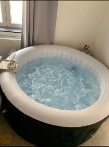 a jacuzzi tub in a room with a window at Sweet Grey SPA in Liège