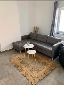 a living room with a couch and a table at Sweet Grey SPA in Liège