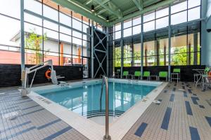 a swimming pool in a large building with windows at Holiday Inn Express & Suites - Chilliwack East an IHG Hotel in Chilliwack