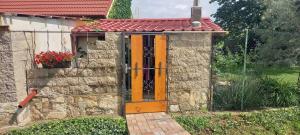 a door on a stone building with a red roof at Apartmán Levandule 