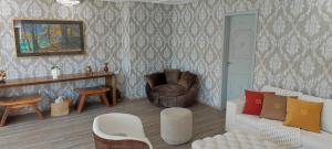 a living room with a couch and a chair at Pousada Serrano in Campos do Jordão