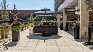 a patio with a couch and an umbrella at Holiday Inn Lancaster, an IHG Hotel in Lancaster