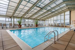 a large indoor swimming pool with a glass ceiling at Omni Richmond Hotel in Richmond