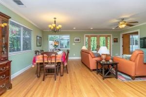 a living room with a table and chairs and a couch at Elegant River Park Sanctuary in Sacramento