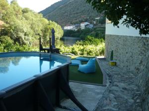 a swimming pool with a view of a mountain at Casa do Riacho in Pinhão