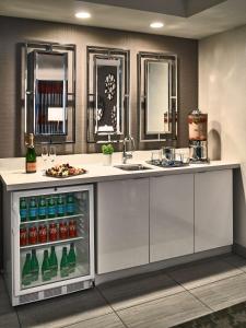 a kitchen with a refrigerator with drinks and a sink at Sonesta Philadelphia Rittenhouse Square in Philadelphia