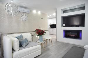 a living room with a white couch and a fireplace at My way in Azores in Horta
