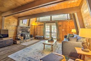 a living room with a couch and a fireplace at Pet-Friendly Cottage, Walk From Big Bear Village! in Big Bear Lake