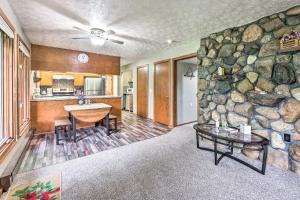 a living room with a stone wall and a table at Mimis Place about Peaceful Duplex with Deck! in Orrville