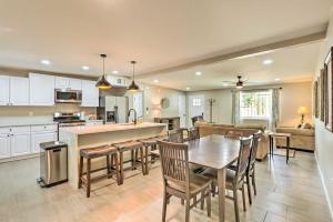 a kitchen and living room with a table and chairs at Tucson Getaway with Private Pool and Gas Grill! in Tucson