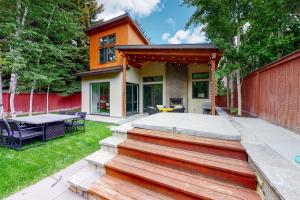 a home with a patio with a table and chairs at Belmont Beauty in Ketchum