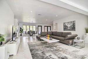 a living room with a couch and a tv at Fort Lauderdale Home Near Shops, Cafes, Beach in Fort Lauderdale