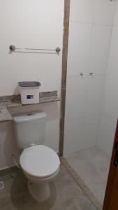 a bathroom with a white toilet and a shower at Star Hotel 205 Apenas diferente in Juiz de Fora +3 photos