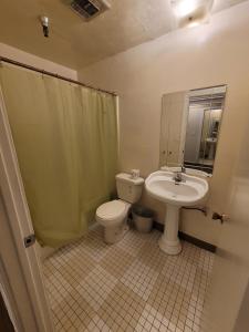 a bathroom with a toilet and a sink at (A11) Lovely Double Bed Unit in Los Angeles