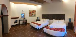 Postel nebo postele na pokoji v ubytování Hotel Hacienda Monteverde San Miguel de Allende
