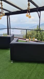 a living room with a black couch on the grass at Hostal San Rafael La Calera in La Calera