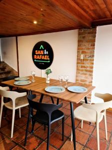 a dining room with a wooden table and chairs at Hostal San Rafael La Calera in La Calera