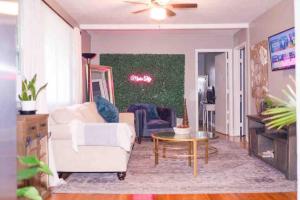 a living room with a white couch and a table at The Green House in Nashville