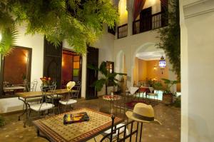 a courtyard with tables and chairs in a building at Riad Alwane in Marrakesh