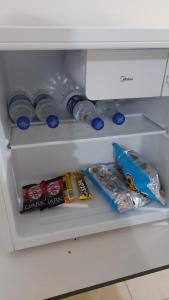 an open refrigerator with food and drinks in it at Star Hotel 206 Diferente in Juiz de Fora