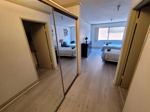 a mirror reflection of a bedroom with two beds at B11 LA Lovely Double Deluxe Unit in Los Angeles
