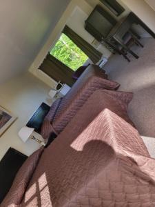 a bedroom with a large bed and a window at Gateway Motel in Gananoque