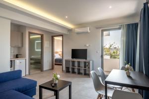 a living room with a blue couch and a table at Orama apartment in Nea Kydonia